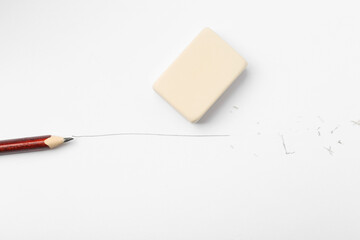 Pencil, eraser, line and scraps on white paper, flat lay