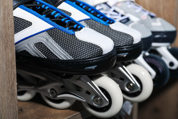 Pairs of roller skates in shelving unit, closeup