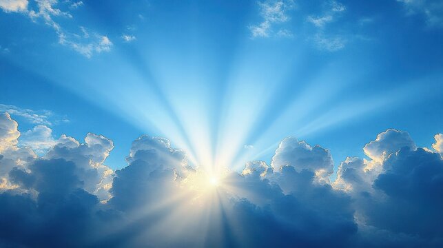 Bright sun rays breaking through thick fluffy clouds in a clear blue sky, creating a serene and uplifting atmosphere