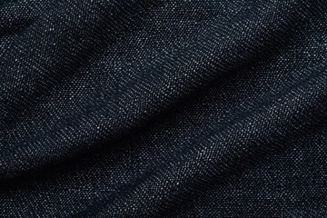 Naklejka premium close-up texture of black denim fabric showing woven pattern and folds