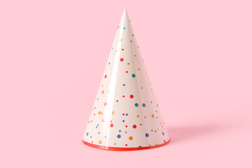 Party hat on pink background, closeup