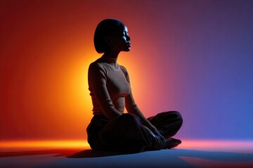 A silhouette of a person sitting in a quiet place surrounded colorful aura