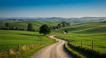 Serpentine country road winds through lush green rolling hills under a vibrant blue sky.