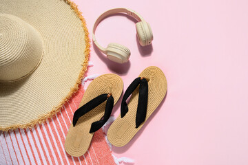 Composition with stylish beach shoes, hat and headphones on pink background, closeup