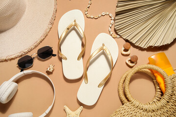 Composition with stylish beach shoes, headphones and accessories on beige background, closeup