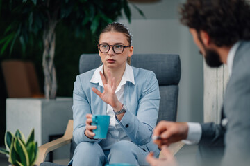Businesswoman gesturing while talking to colleagues during a meeting