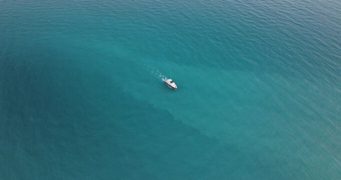 Aerial view of turquoise ocean and boats, Cyprus.