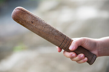 Hand holding a Pestle. Selective focus with shallow depth of field.