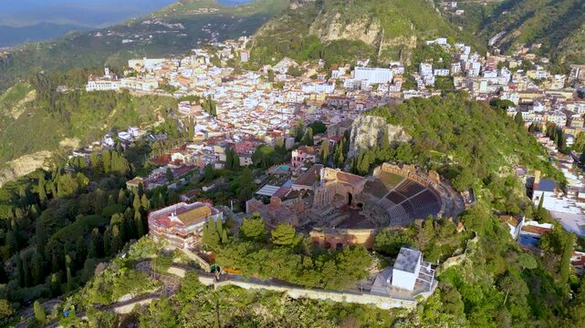 Aerial drone view of Teatro Antico di Taormina during sunrise, Sicily, italy