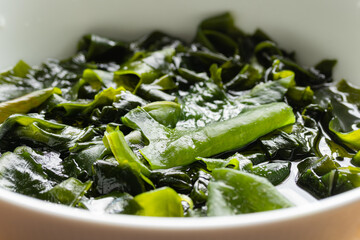 Sea mustard or wakame seaweed soaked in water