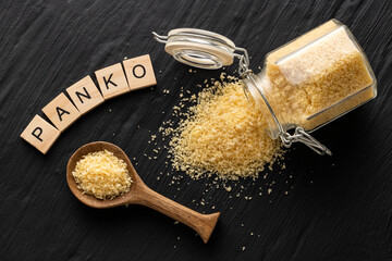 Yellow Japanese panko crumbs in a spoon and glass jar