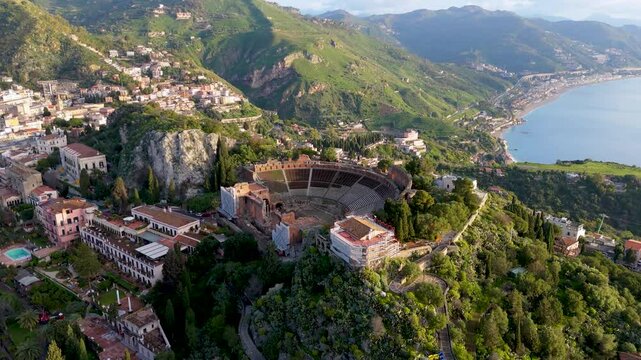 Aerial drone view of Teatro Antico di Taormina during sunrise, Sicily, italy