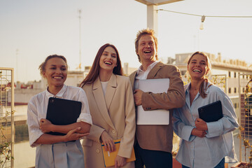A Group of Happy Professionals Smiling Together Outdoors in an Urban Environment
