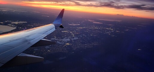 Sunset View from Airplane Window with Wing in Frame