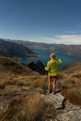 hiker enjoying the  Lake scenery of an alpine lake hiking up  the Isthmus track trail
