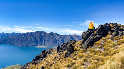 hiker enjoying the  Lake scenery of an alpine lake hiking up  the Isthmus track trail