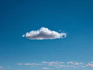 Harness Negative Space in Sky Photography Featuring a Lone Cloud Against a Minimalist Blue Canvas