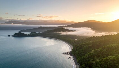 Coastal sunrise over lush rainforest