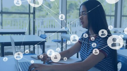 Teenage female student typing on laptop and activating tech network icons swirling around screen - Powered by Adobe