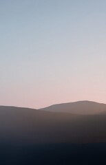 Fototapeta premium Minimalist mountain range at dawn sunrise