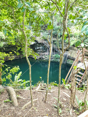 View of the popular X’Canche Cenote, a  natural limestone cavern with a deep natural pool of fresh water near Ek Balam,near Valladolid,Yucatan,Mexico