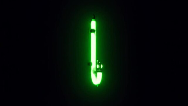 Neon Letter J Glowing Brightly in Vibrant Green Light Against Dark Background