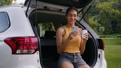 African American woman drinking coffee smiling relaxing happy female girl holding mobile phone...