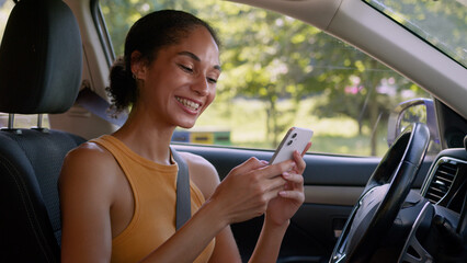 Happy African American woman user mobile phone smartphone enjoyment good news win achievement smile...