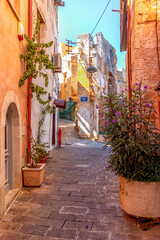 Narrow street and historic stone ruins in Chania, Crete