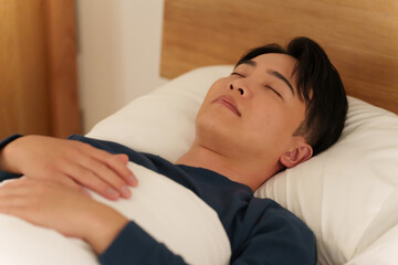 夜ベッドで寝る男性