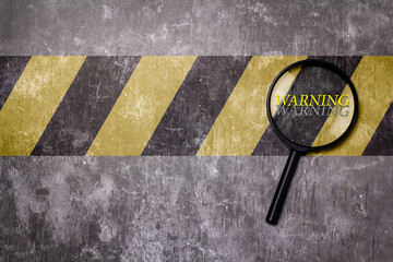 Safety sign on a yellow and black stripe
