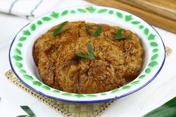 Kue Cucur, Indonesian traditional cake, made from rice floor, palm sugar. Popular street food in Indonesia for tea time or snacking time. Isolated background.