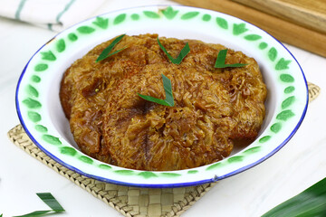 Kue Cucur, Indonesian traditional cake, made from rice floor, palm sugar. Popular street food in Indonesia for tea time or snacking time. Isolated background.