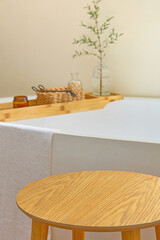 Scenic bath space with side table and tray over tub. Clean minimalist design, soft textures and...