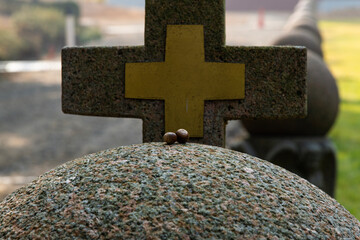 acorn on the stone sculpture with cross