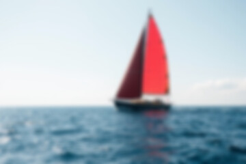 Fototapeta premium blurry photo of a small sailing ship sailing in the middle of the vast ocean, Wallpaper.