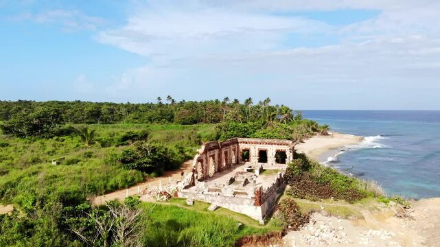 Aerial (drone) view of the ruins of the Spanish lighthouse at Punta Borinquen beach, Aguadilla, Puerto Rico