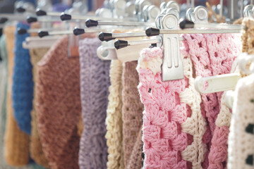Colorful crochet pieces displayed at a local market