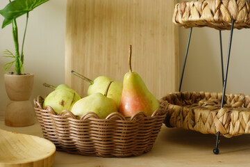 Fresh fruits in a wicker basket on a wooden table