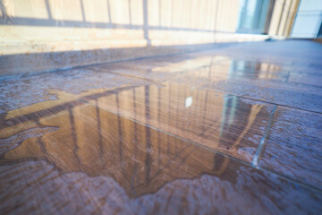 Reflection of sunlight on a wet floor in a modern building