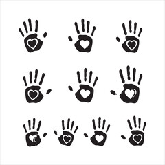 Fototapeta premium Collection of black handprints with white hearts symbolizing love and care