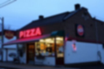 blurry photo of pizza shop at night, showing the lights and pizza logo beautifully lit, typical italian food, wallpaper.