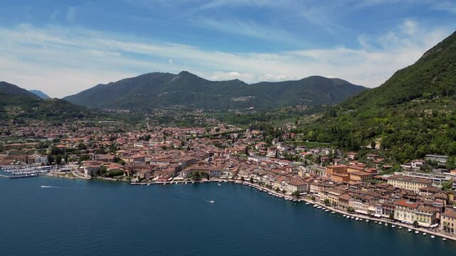 Europe, Italy, Brescia , Garda lake , Salo' drone aerial view of village with church and lake with blue water - Italian Republic from 1943 to 1945 during the reign of Benito Mussolini fascist