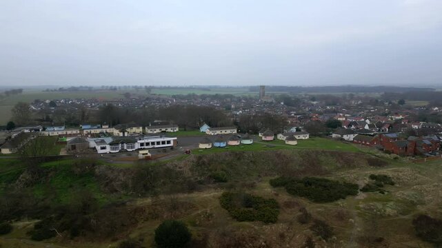 Drone parallax shot showing Hermanus huts and village layers in motion