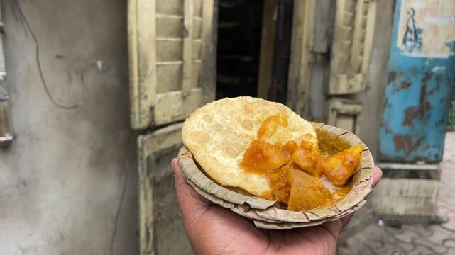 Radhaballabhi and alu dum in front of old heritage gate in Bengal, India