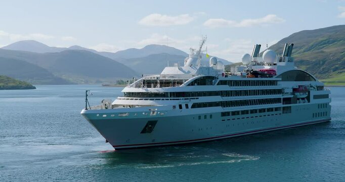 Stunning drone panning shot of the luxury cruise ship Le Lyrial anchored in Loch Broom, Ullapool, Scotland, 2025.