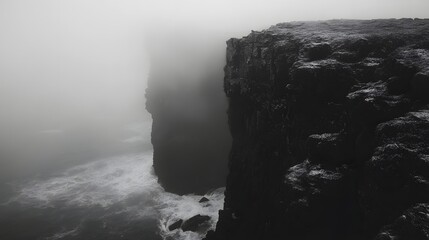 Misty cliffs meet the turbulent ocean.