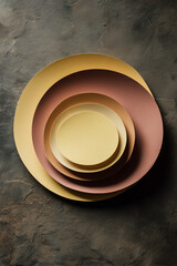Artistic Display of Circular Plates in Varying Tones of Yellow and Red, with Textured Backdrop
