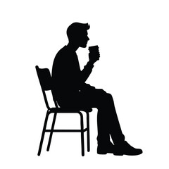 Silhouette of a Man Sitting on a Chair and Drinking Coffee