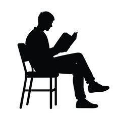 Silhouette of a Person Reading a Book While Seated on a Chair
